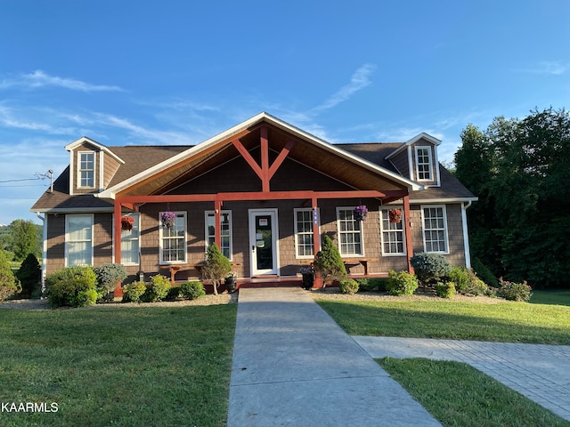 view of front of property with a front yard and covered porch