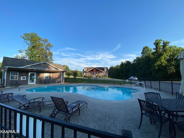 view of swimming pool with an outbuilding and a patio area