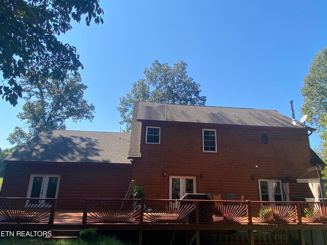 rear view of house with a wooden deck and french doors