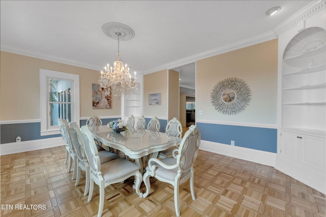 dining space featuring a chandelier, light parquet flooring, and crown molding