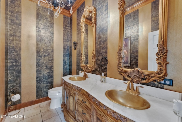 bathroom featuring tile patterned flooring, vanity, toilet, and ornamental molding