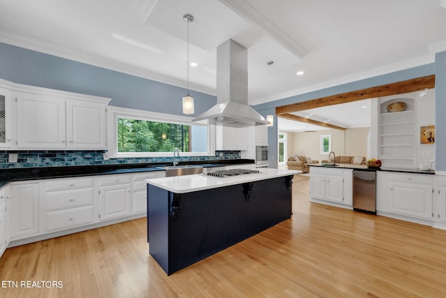 kitchen with island exhaust hood, white cabinetry, stainless steel appliances, and decorative light fixtures