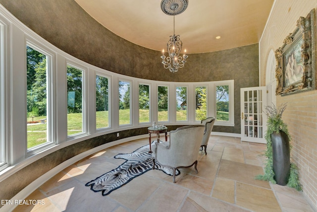 sunroom / solarium with a chandelier