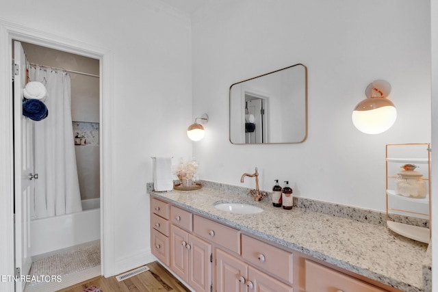 bathroom featuring vanity, wood-type flooring, and shower / tub combo with curtain