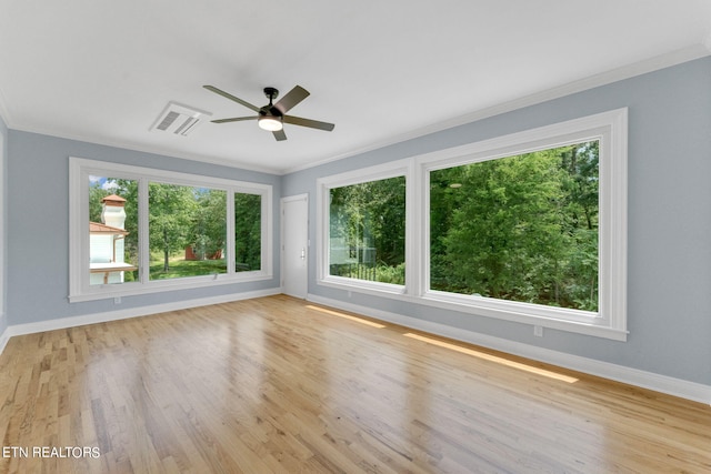 spare room featuring crown molding, ceiling fan, and light hardwood / wood-style floors