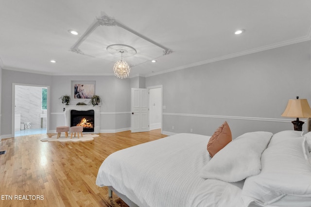 bedroom with hardwood / wood-style floors, a notable chandelier, and ornamental molding