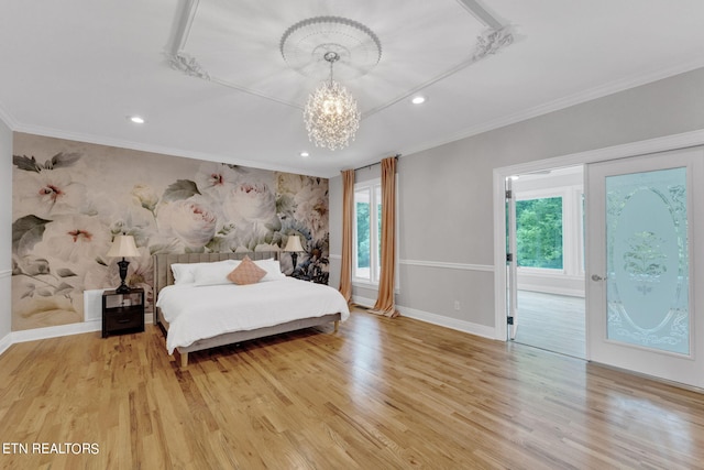 bedroom featuring a notable chandelier, light hardwood / wood-style floors, ornamental molding, and multiple windows