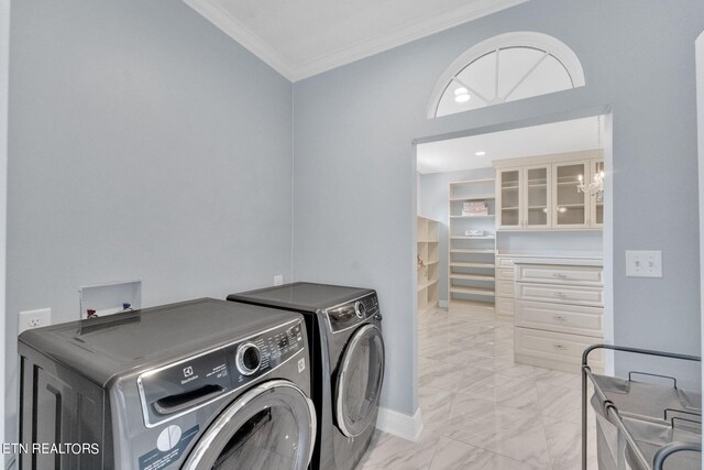 laundry room with washer and clothes dryer, ornamental molding, and an inviting chandelier