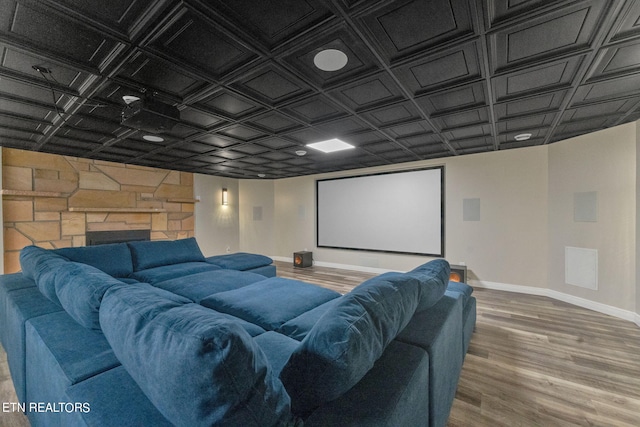 home theater room featuring a fireplace and wood-type flooring