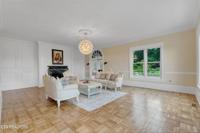 unfurnished living room with a notable chandelier, french doors, ornamental molding, and light parquet flooring