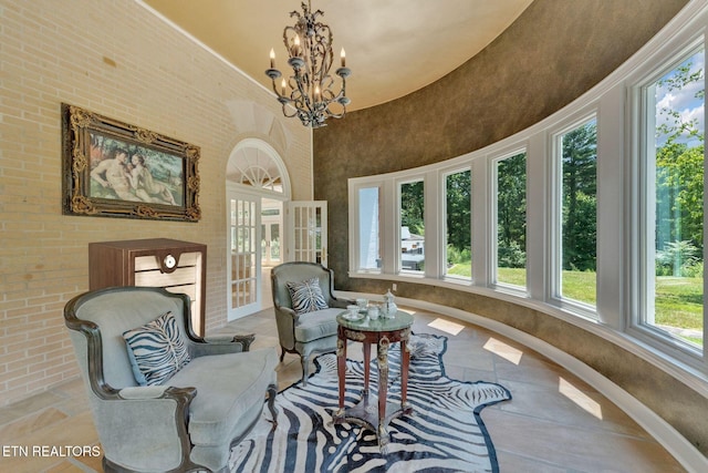 sitting room with a towering ceiling and a notable chandelier