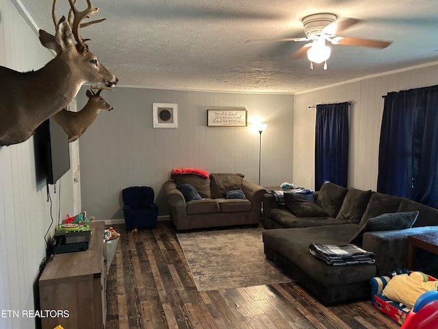 living room with ceiling fan, dark wood-type flooring, and a textured ceiling