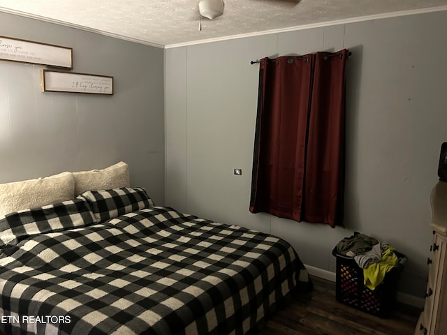 bedroom with a textured ceiling and dark wood-type flooring