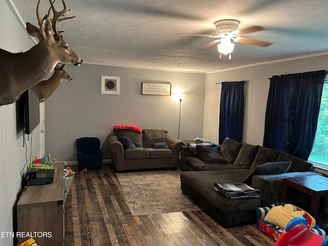 living room with dark hardwood / wood-style flooring, ceiling fan, and a textured ceiling