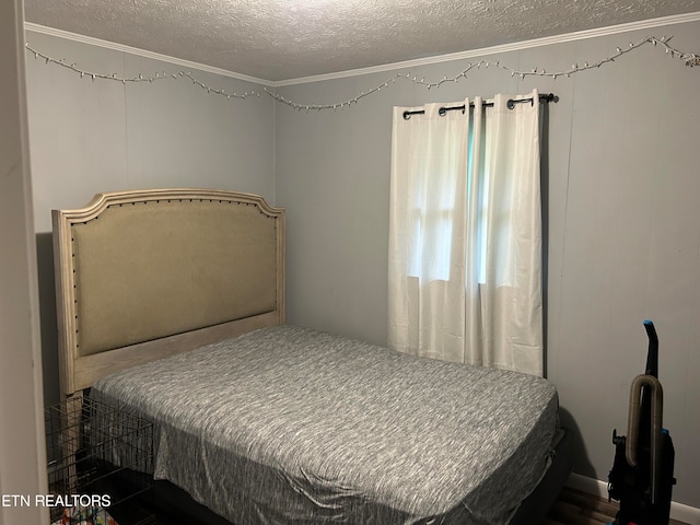 bedroom with crown molding and a textured ceiling