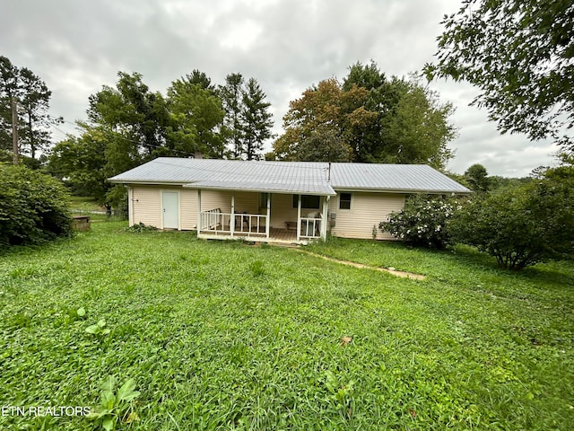 rear view of house with a lawn