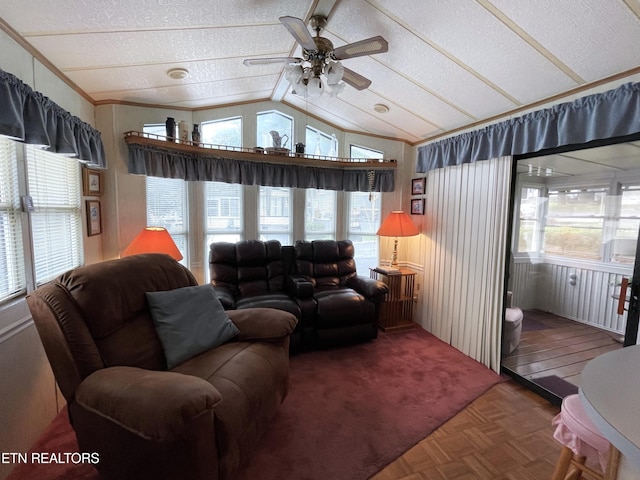 living room with ceiling fan, a wealth of natural light, and parquet floors