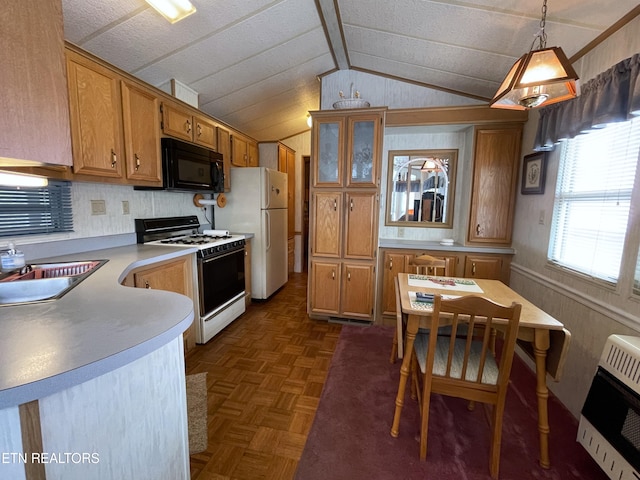 kitchen featuring decorative light fixtures, lofted ceiling, white appliances, heating unit, and dark parquet floors