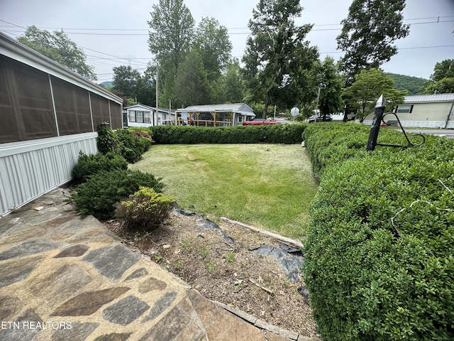 view of yard featuring a sunroom