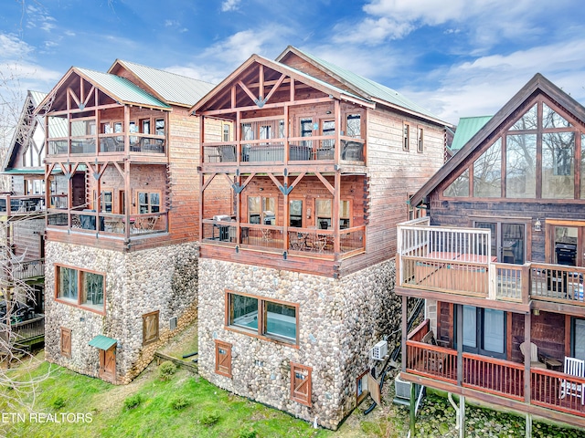 rear view of property featuring a balcony