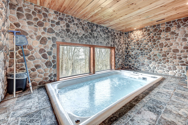 view of swimming pool featuring an indoor hot tub