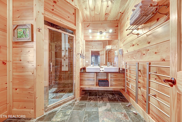 bathroom with wood ceiling, wooden walls, tile floors, vanity, and a shower with door