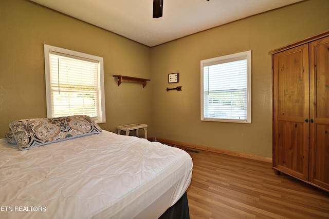 bedroom featuring light hardwood / wood-style flooring and ceiling fan