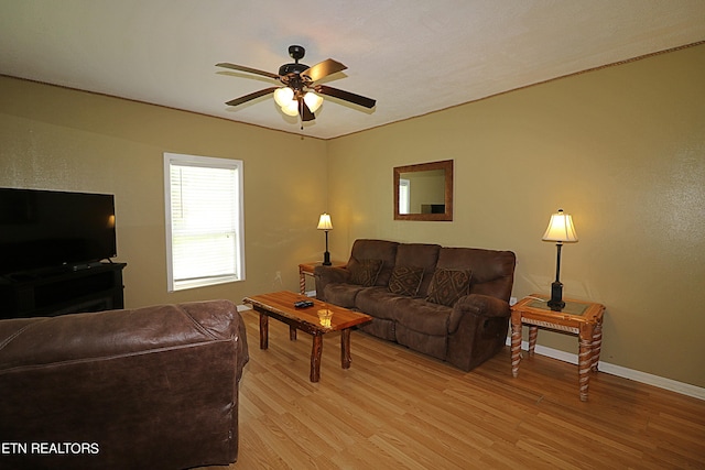 living room featuring ceiling fan and light wood-type flooring