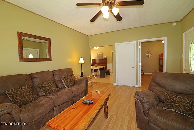 living room with ceiling fan and light hardwood / wood-style flooring