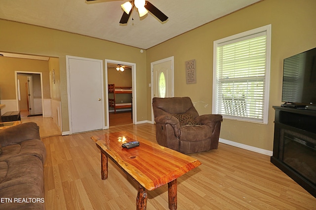 living room featuring ceiling fan and light wood-type flooring