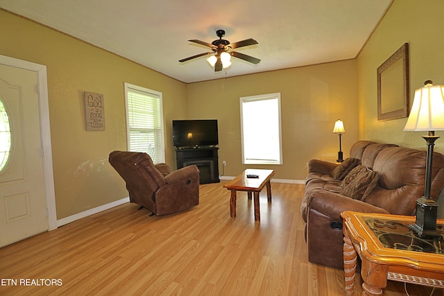 living room with ceiling fan and light hardwood / wood-style floors