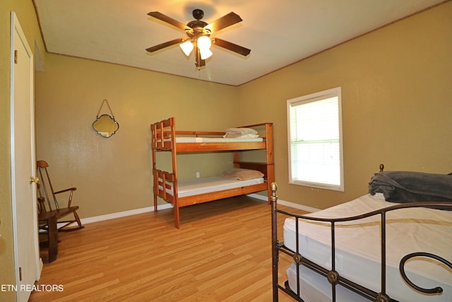 bedroom with ceiling fan and light hardwood / wood-style floors