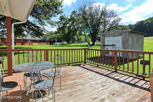 wooden deck with a lawn and a shed