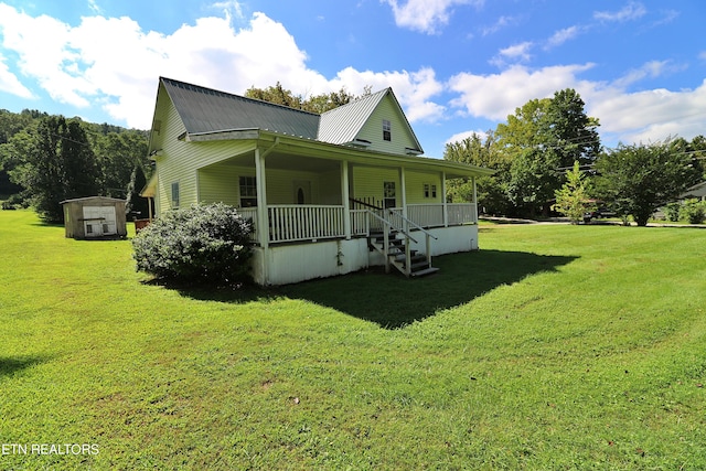 view of front facade with a front lawn, a storage unit, and covered porch