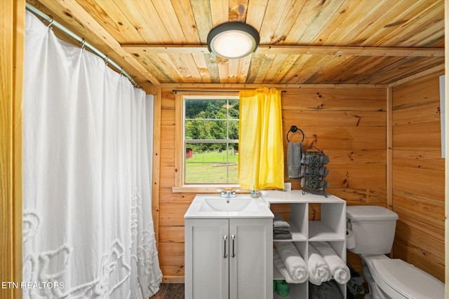 bathroom featuring wooden ceiling, vanity, toilet, and wooden walls