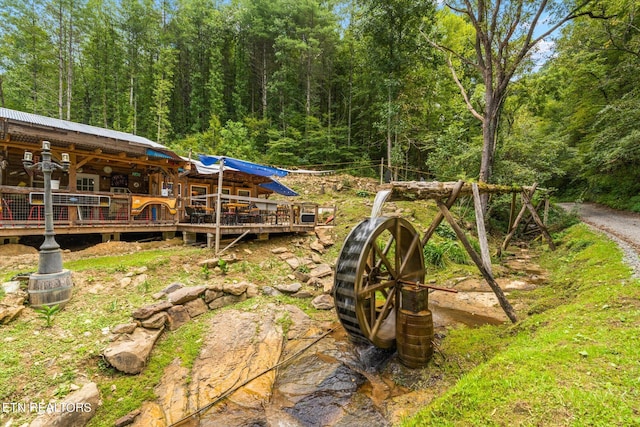 view of yard featuring a deck with water view