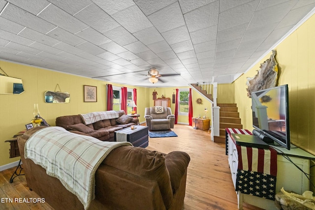 living room featuring ceiling fan and light hardwood / wood-style flooring