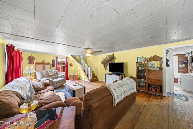 living room featuring ceiling fan and hardwood / wood-style flooring