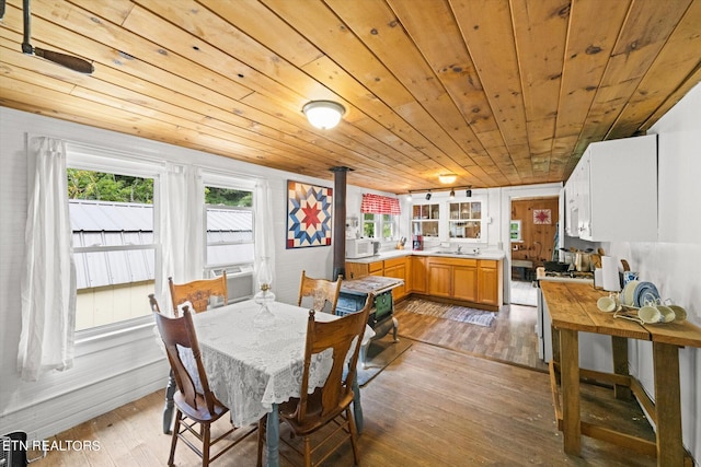 dining room featuring plenty of natural light, wooden ceiling, light hardwood / wood-style flooring, and sink