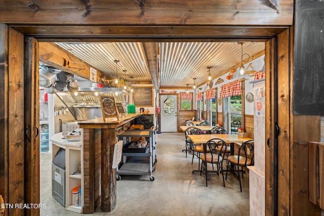 dining area with wood ceiling and concrete floors