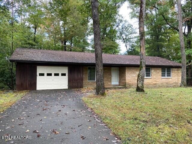 ranch-style home with a front yard and a garage