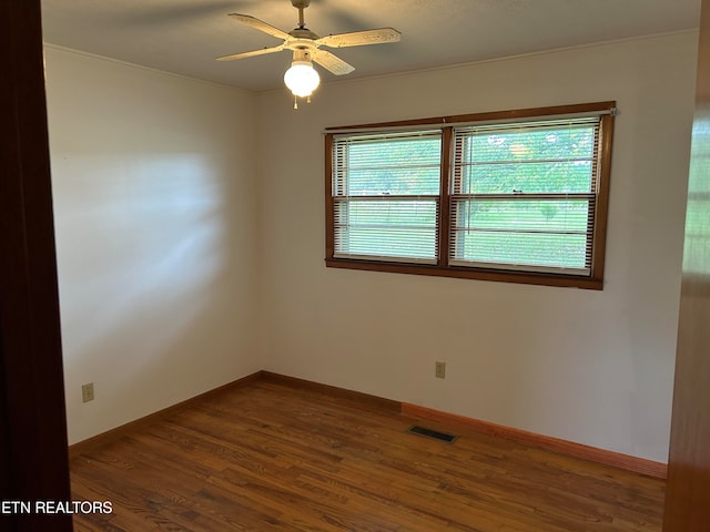 unfurnished room featuring dark hardwood / wood-style flooring and ceiling fan