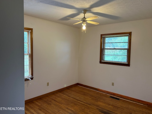 unfurnished room featuring ceiling fan, hardwood / wood-style flooring, and a textured ceiling