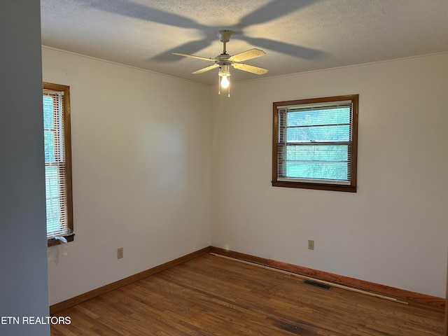 unfurnished room featuring ceiling fan, hardwood / wood-style flooring, and a textured ceiling