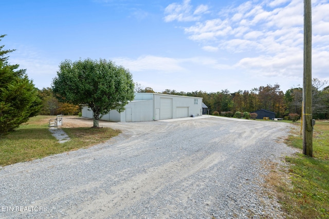 view of front of house featuring a garage and an outdoor structure