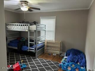 bedroom featuring crown molding, dark hardwood / wood-style flooring, and ceiling fan