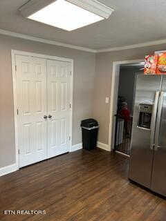 interior space featuring a closet, stainless steel refrigerator with ice dispenser, and dark wood-type flooring