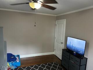 unfurnished bedroom featuring ornamental molding, ceiling fan, and dark hardwood / wood-style floors