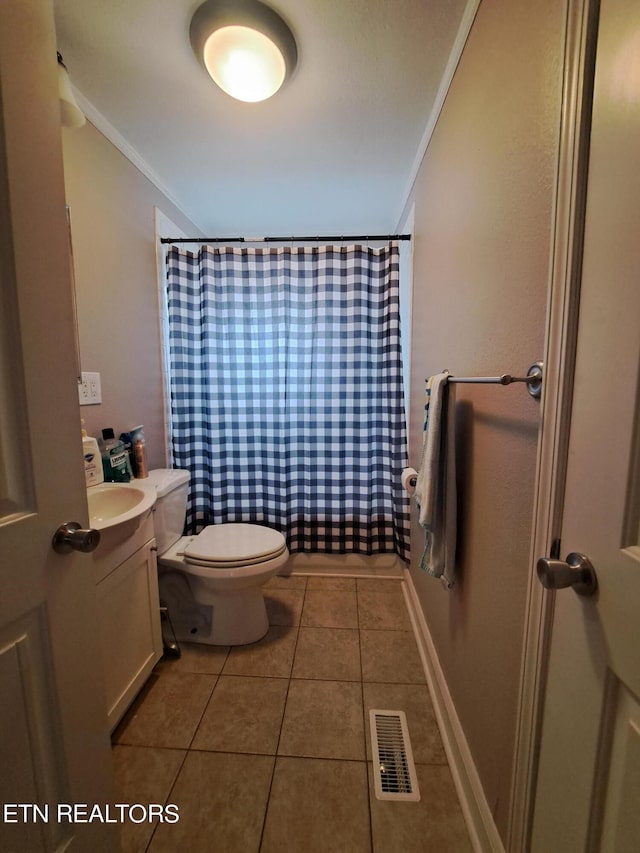 bathroom with vanity, crown molding, toilet, and tile flooring