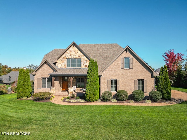 view of front of property featuring a front lawn and covered porch